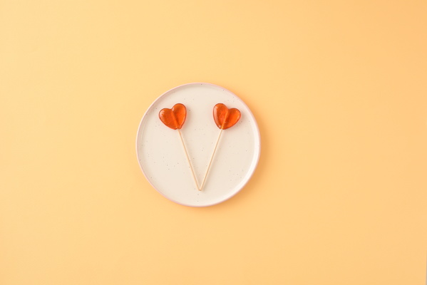 Lollipops in Shape of Heart Lying on Plate